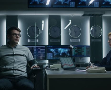 Female Special Agent Conducts Lie Detector Test on a Young Suspect. Corporate Spy Undergoes Polygraph Test, Expert Examiner Questions Accused in Interrogation Room. Computer Measures Reactions. Shot on RED EPIC-W 8K Helium Cinema Camera.
